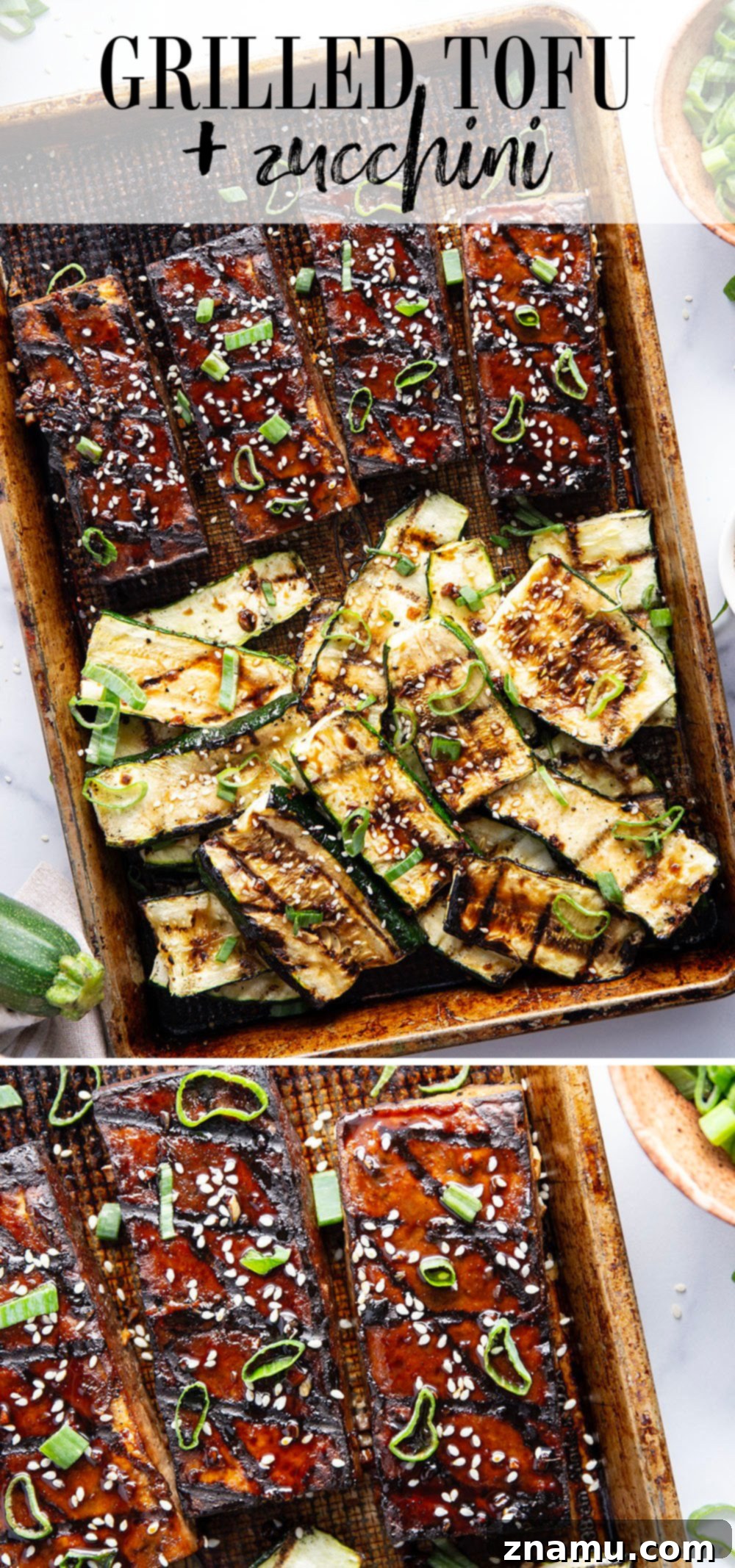 Overhead shot of grilled tofu and zucchini slices on a wooden cutting board with a small bowl of marinade.
