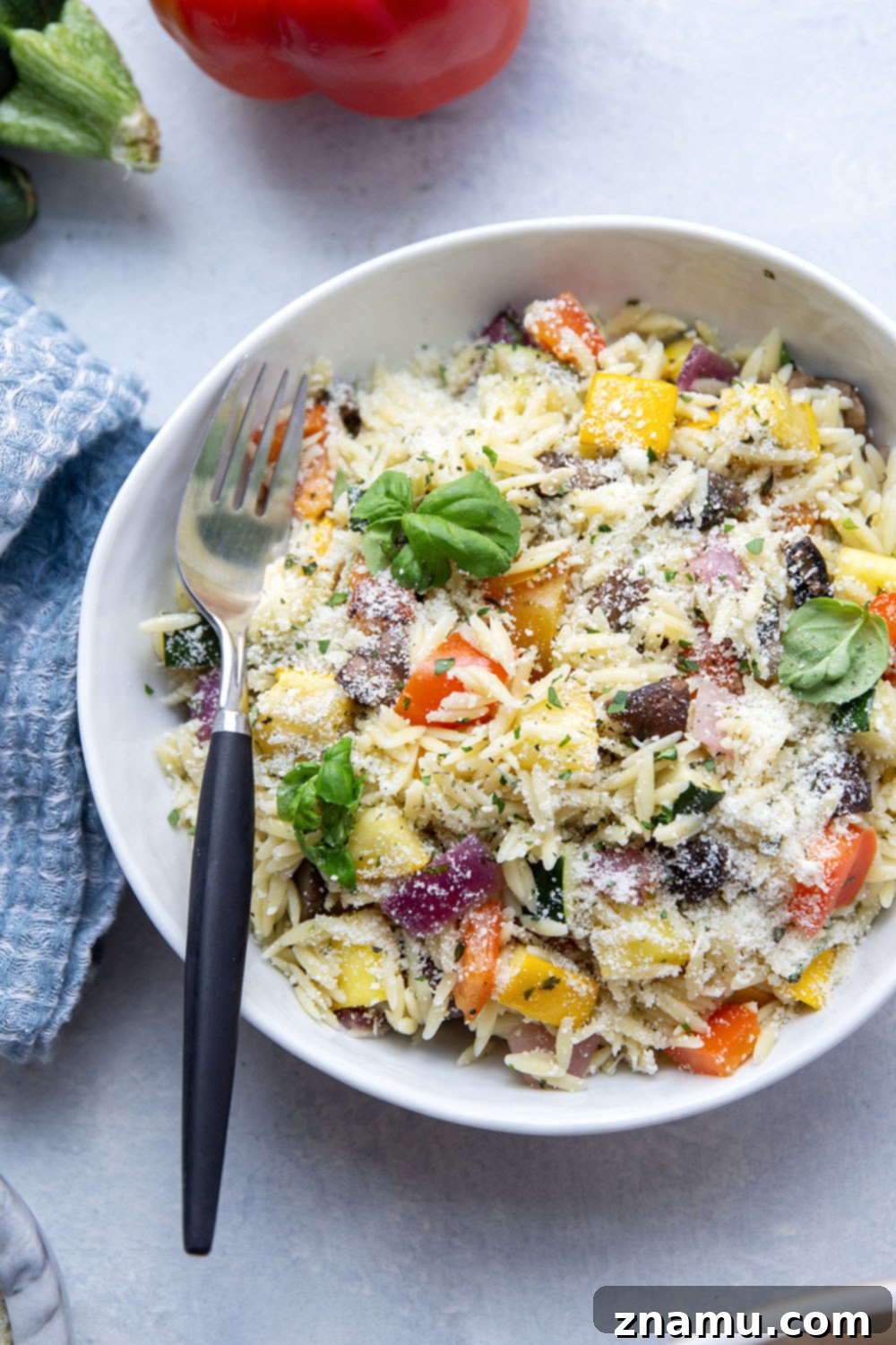 Charred Veggie Orzo Salad 5 Grilled vegetable orzo salad served in a decorative bowl, ready for a summer meal.