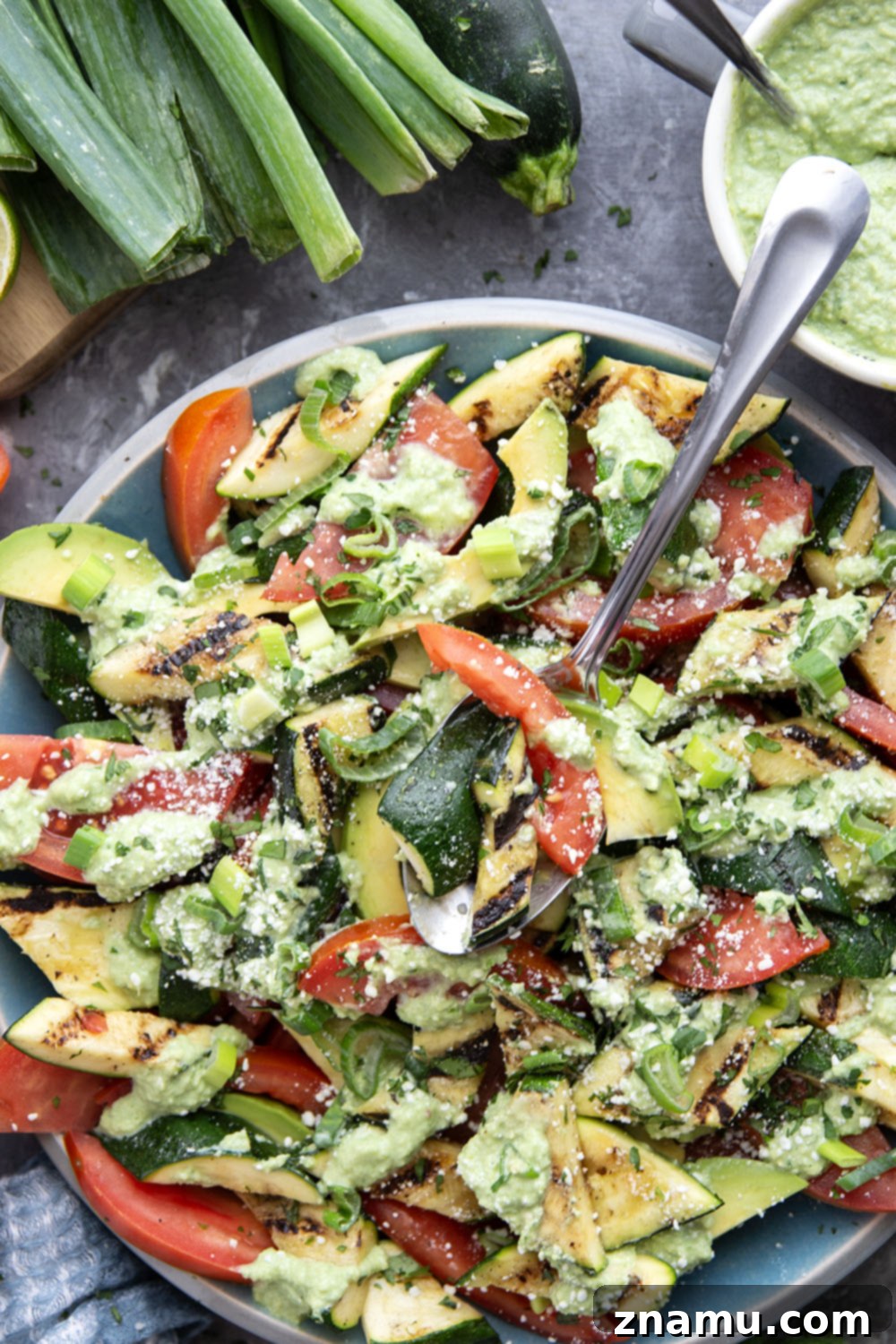 Smoky Grilled Zucchini and Heirloom Tomato Salad with Creamy Avocado-Scallion Dressing 5 A vibrant bowl of Grilled Zucchini Tomato Salad, showcasing the rich colors of the ingredients and the creamy dressing.
