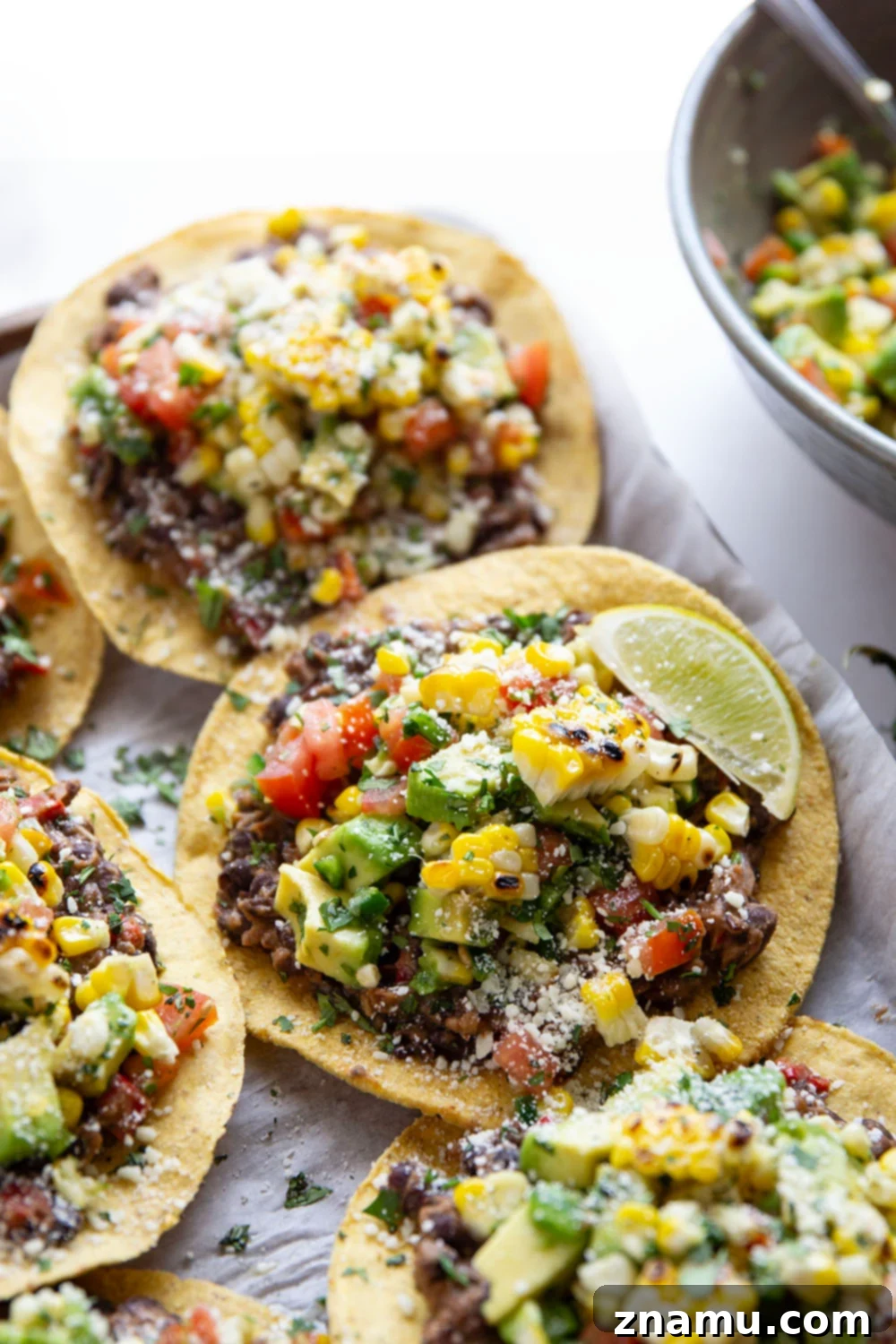 Summer Black Bean Tostadas with Smoky Corn Salsa 2 Creamy smashed black beans and a smoky grilled corn avocado salsa are piled onto these massively flavorful black bean tostadas for an easy vegetarian or vegan meal.