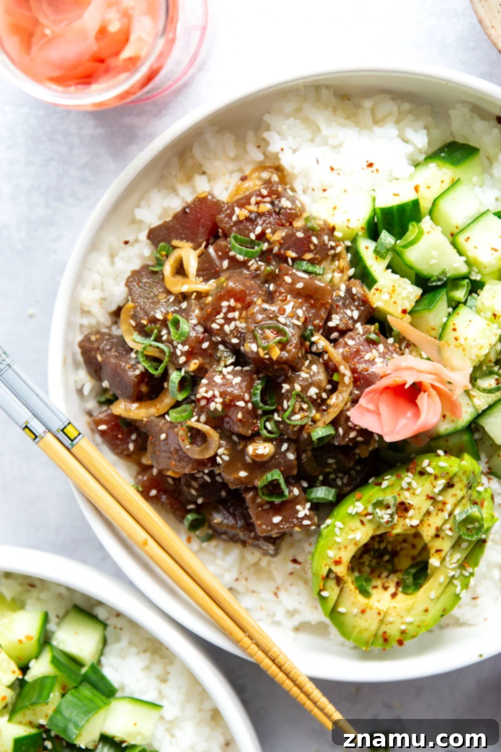 Bowls filled with sushi rice, topped with a colorful assortment of fresh poke ingredients