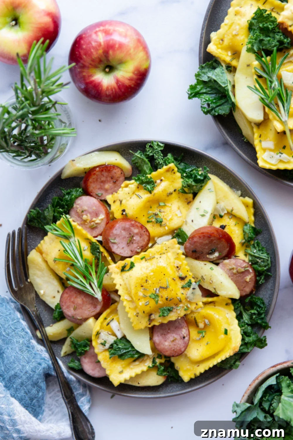 Sheet Pan Sausage, Apple, and Ravioli Bake 4 A close-up shot of the savory sausage slices perfectly roasted and coated in the maple mustard sauce, alongside tender apples.