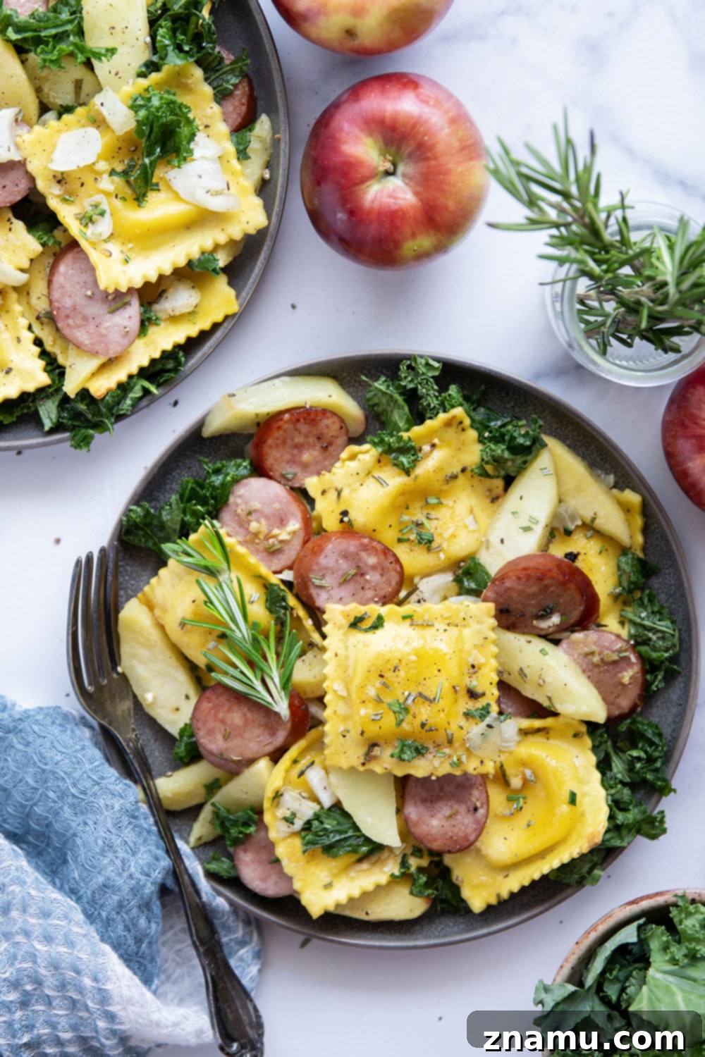 Sheet Pan Sausage, Apple, and Ravioli Bake 6 A generous serving of sheet pan ravioli with sausage and apples, showcasing the golden-brown ravioli and caramelized ingredients.