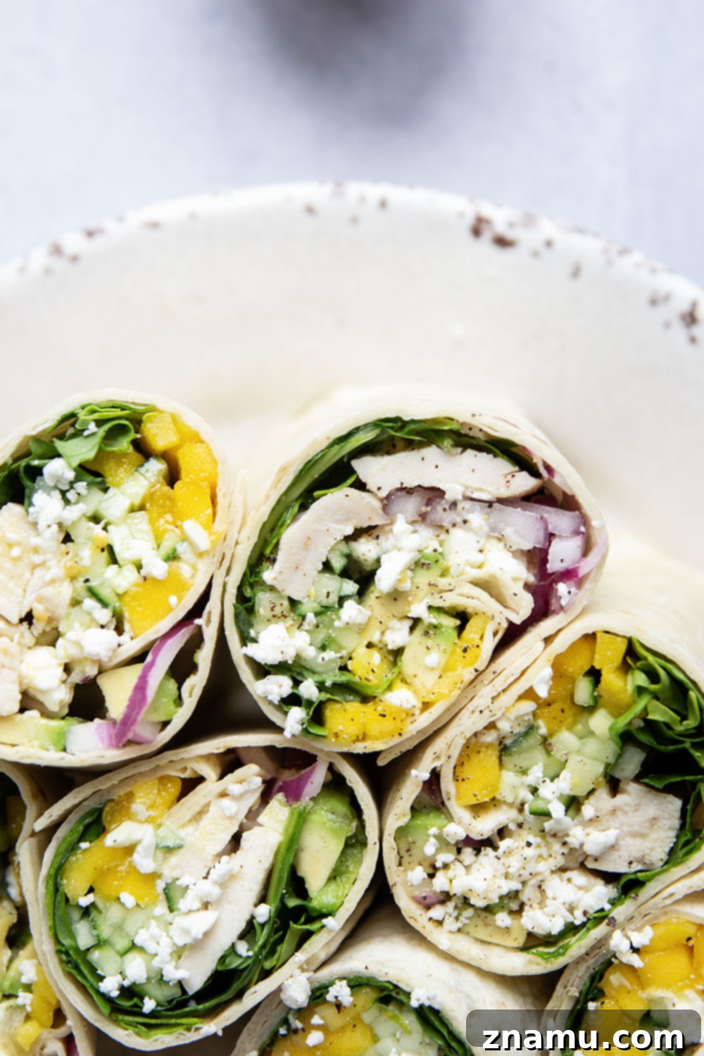 Tropical Chicken Mango Wrap 4 Fresh ingredients for the chicken mango wrap laid out on a board