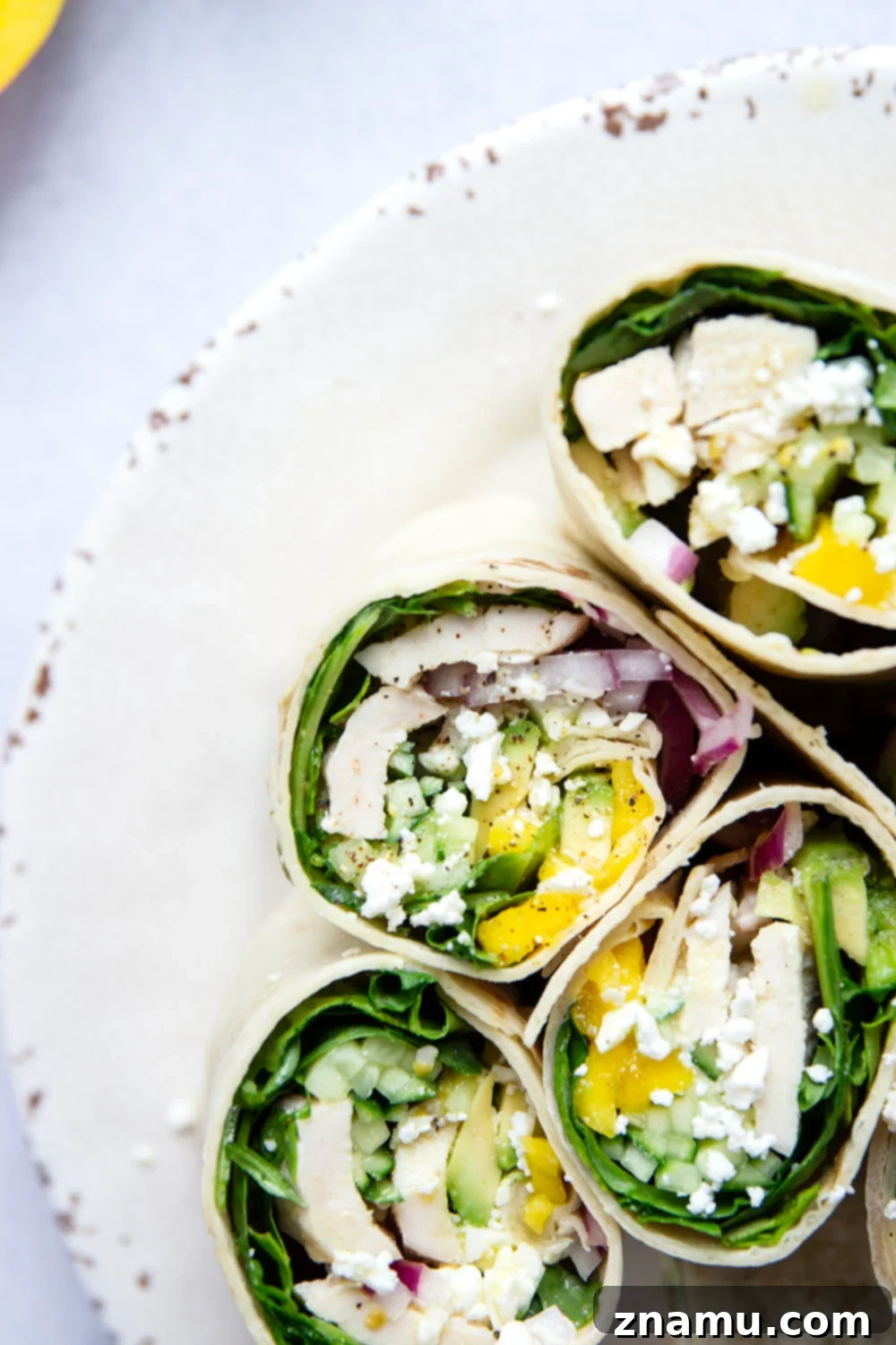 Tropical Chicken Mango Wrap 6 Two halves of a beautifully assembled chicken mango wrap