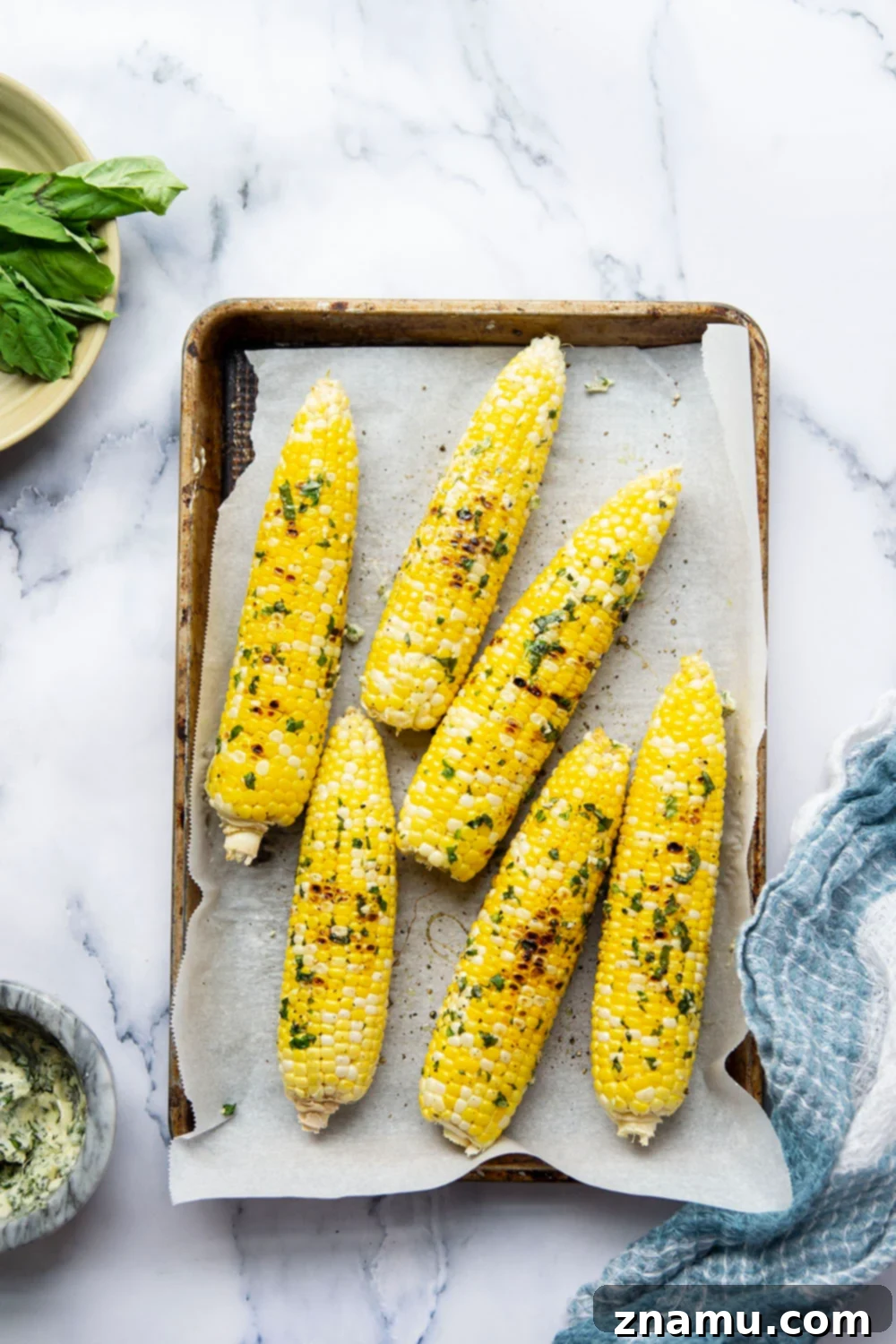 Irresistible Grilled Corn with Basil Butter 3 Close-up of grilled corn with basil butter, showing tender kernels and a slight char