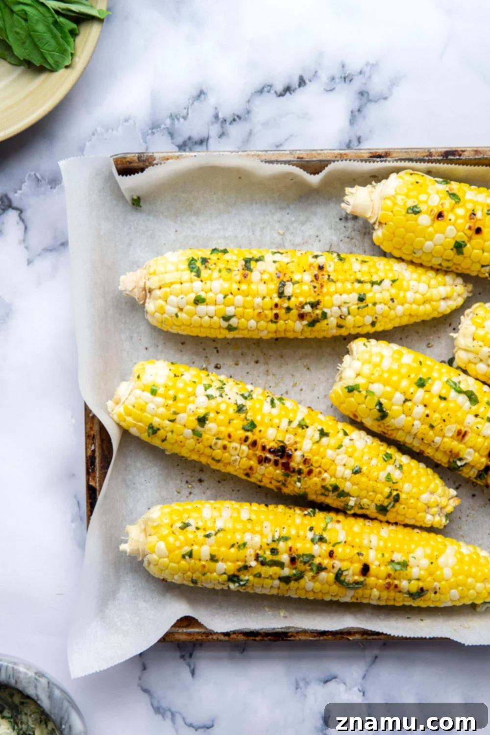 Irresistible Grilled Corn with Basil Butter 4 Grilled corn on the cob with basil butter, close-up on texture