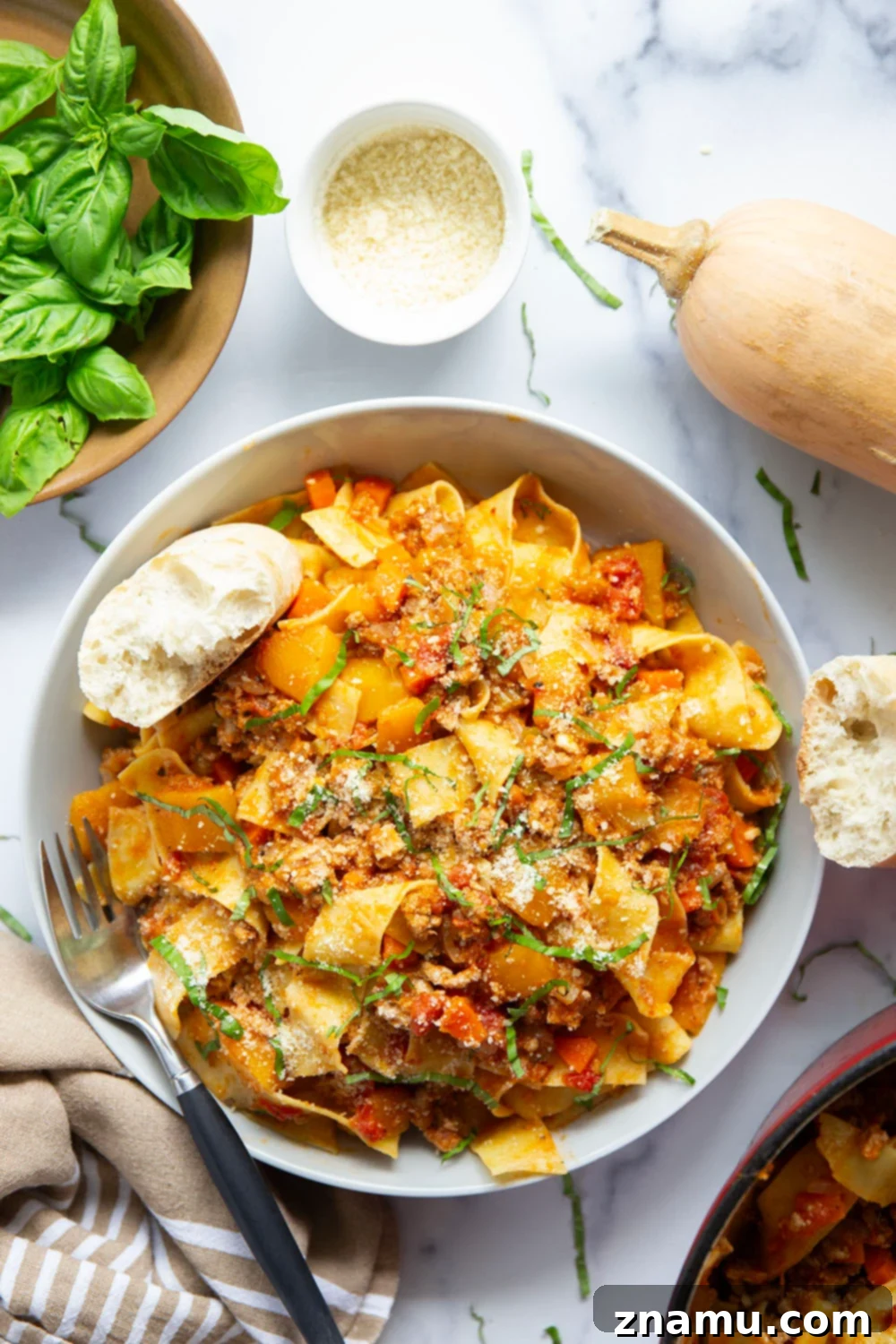 Golden Butternut Turkey Ragu 5 Cooked pappardelle pasta being tossed with Butternut Squash Turkey Bolognese sauce.