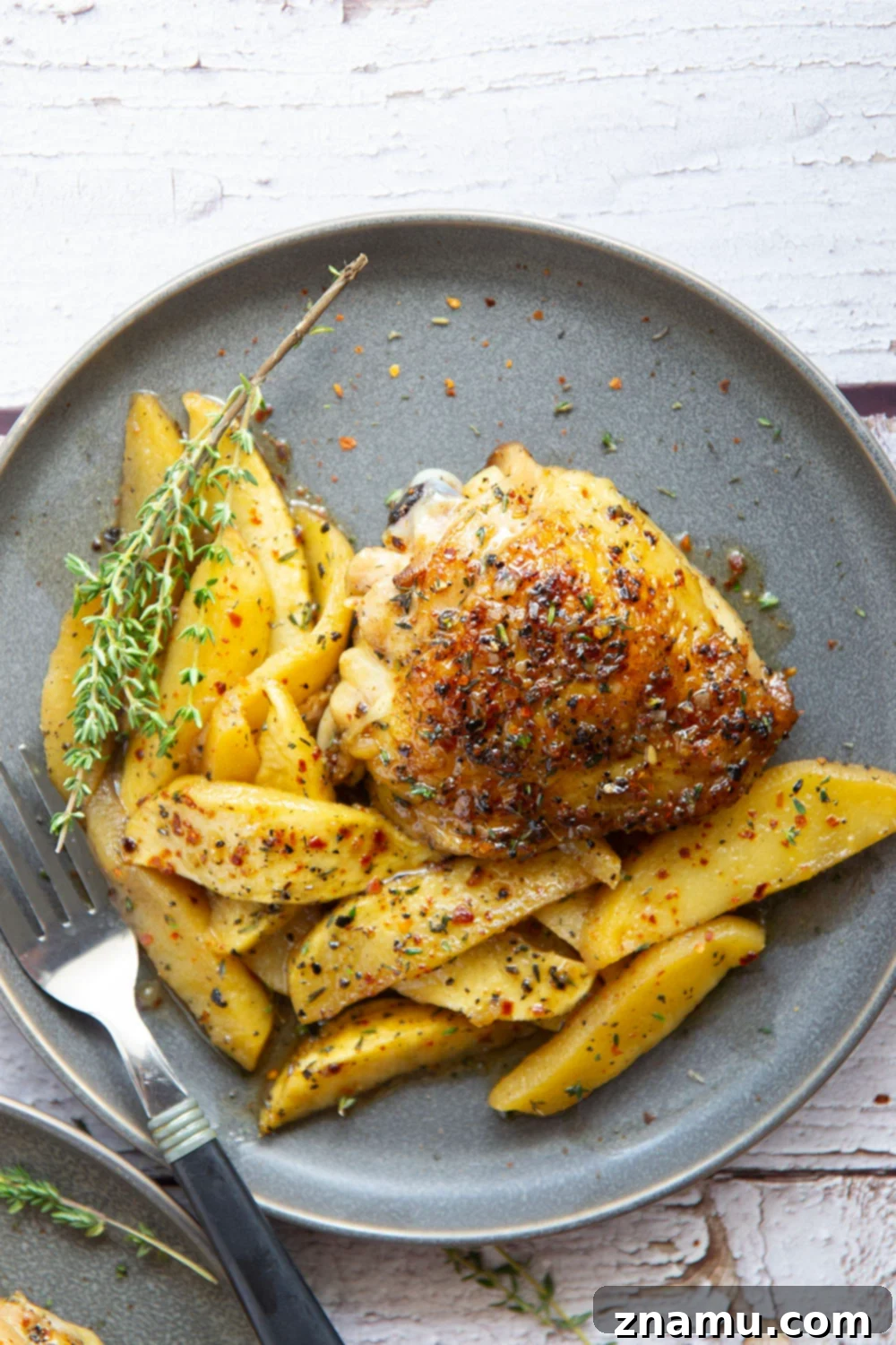 Maple Chili Glazed Chicken Thighs with Apples 2 Baked alongside tender fall apples in a sweet and spicy chili maple glaze, these maple chicken thighs are a quick and flavorful fall dinner for any occasion.