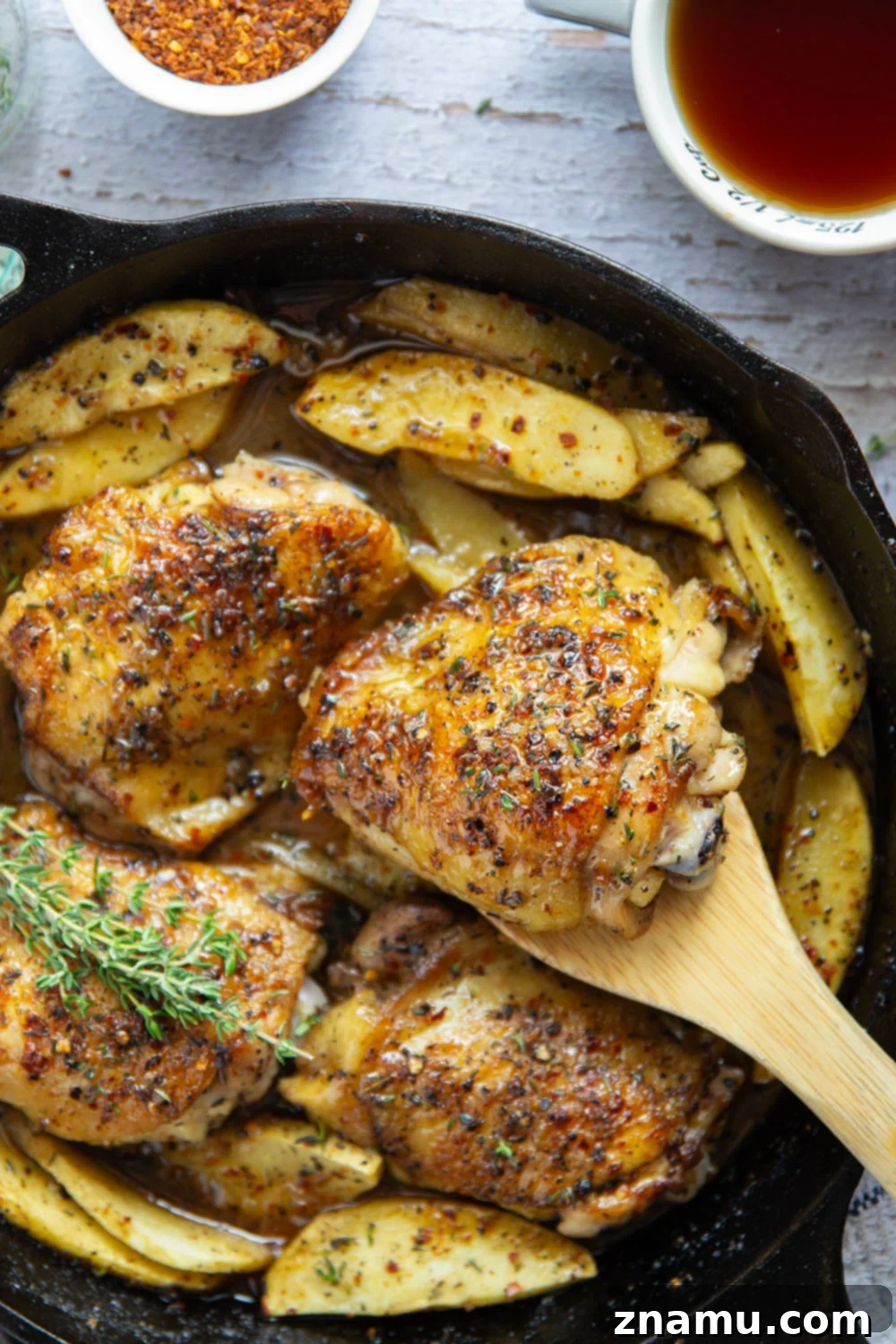 Maple Chili Glazed Chicken Thighs with Apples 5 Baked alongside tender fall apples in a sweet and spicy chili maple glaze, these maple chicken thighs are a quick and flavorful fall dinner for any occasion.