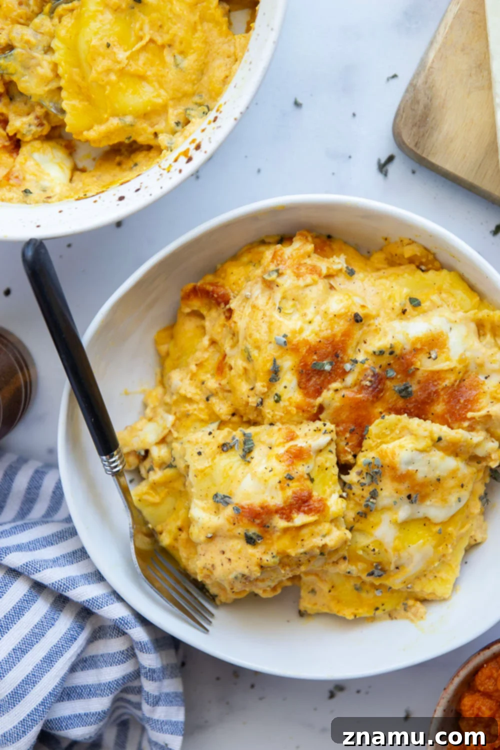 Golden Pumpkin Ravioli Bake 6 Individual serving of baked pumpkin ravioli on a plate