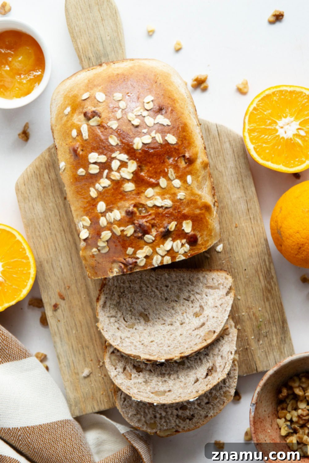 Sun-Kissed Orange Walnut Loaf 4 Cross-section of Orange Walnut Yeast Bread, revealing its soft texture and generous walnut distribution.