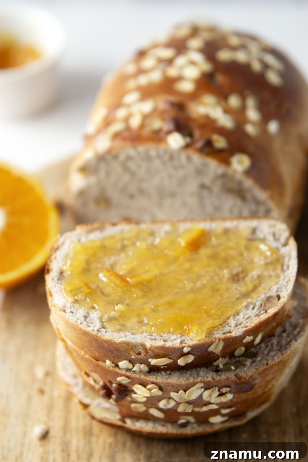 Sun-Kissed Orange Walnut Loaf 6 A large slice of toasted Orange Walnut Yeast Bread topped with butter and orange marmalade.