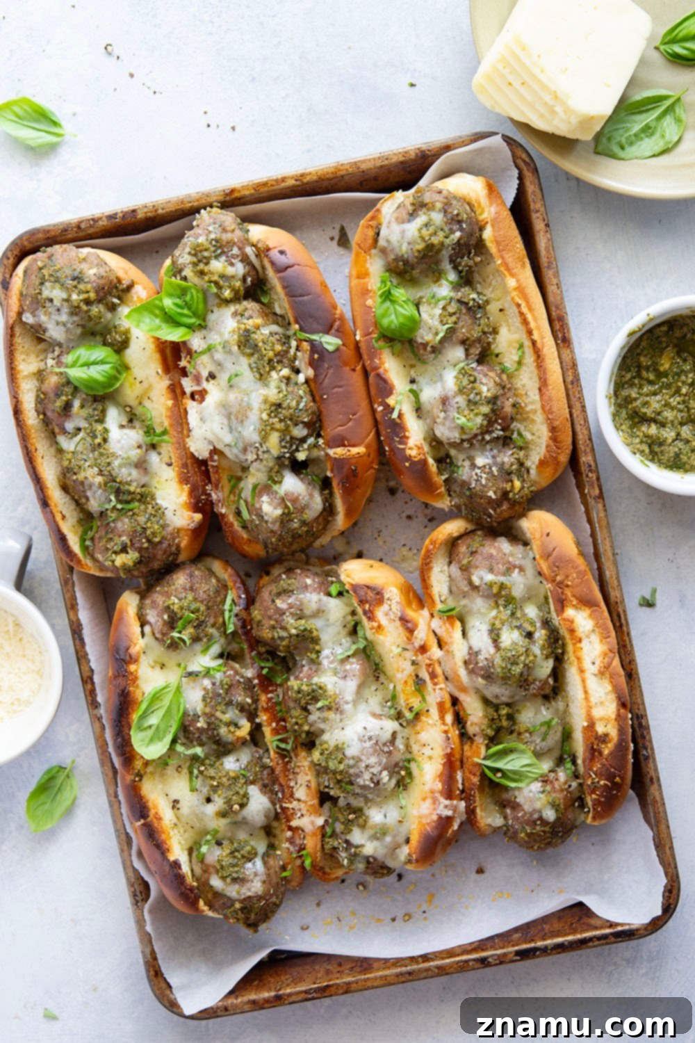 Raw ingredients for pesto meatball sandwiches, including ground turkey, pork, pesto, and Havarti cheese.