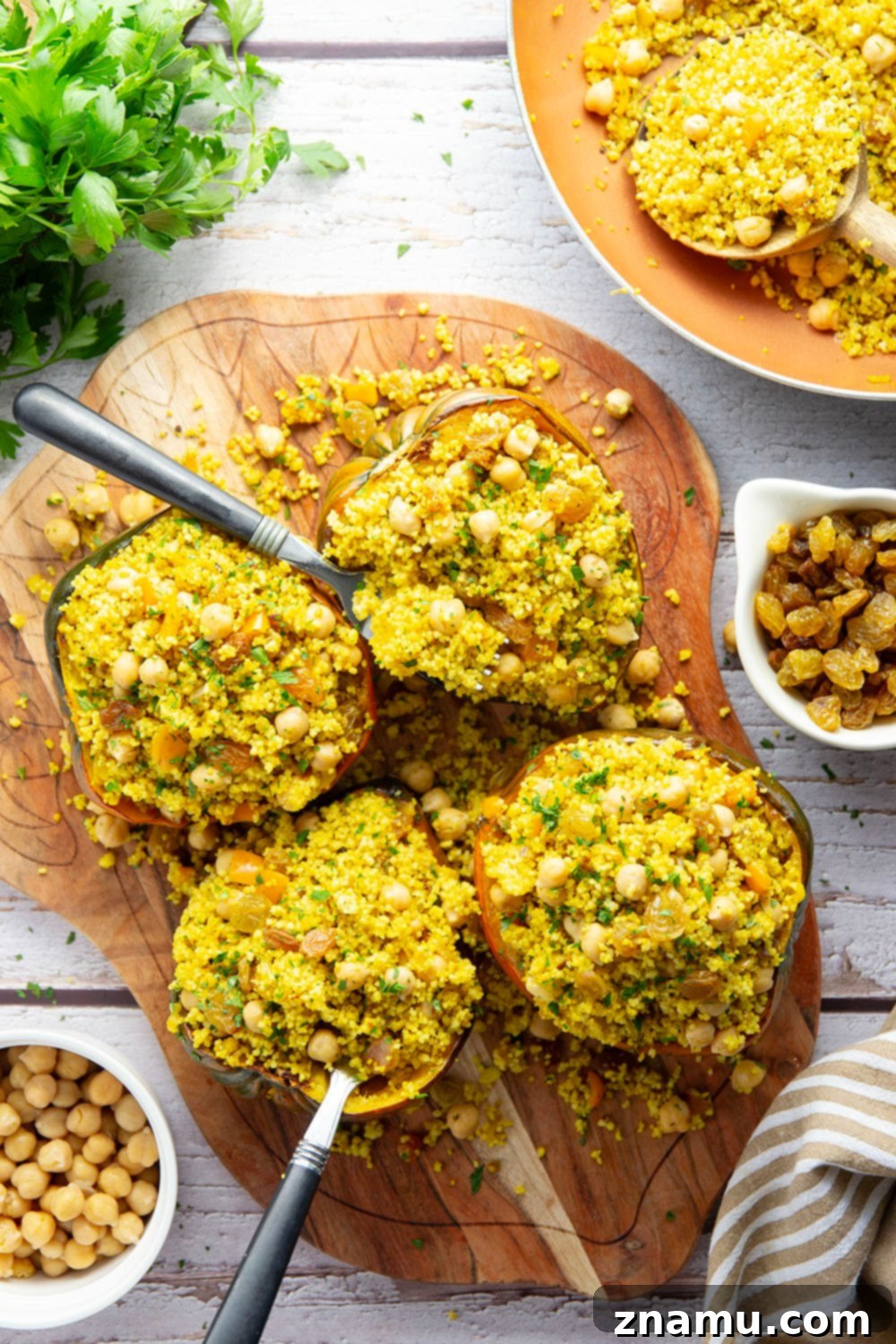 Roasted Acorn Squash with Spiced Couscous 2 This couscous stuffed acorn squash features fluffy Moroccan-spiced golden couscous piled into tender acorn squash boats.