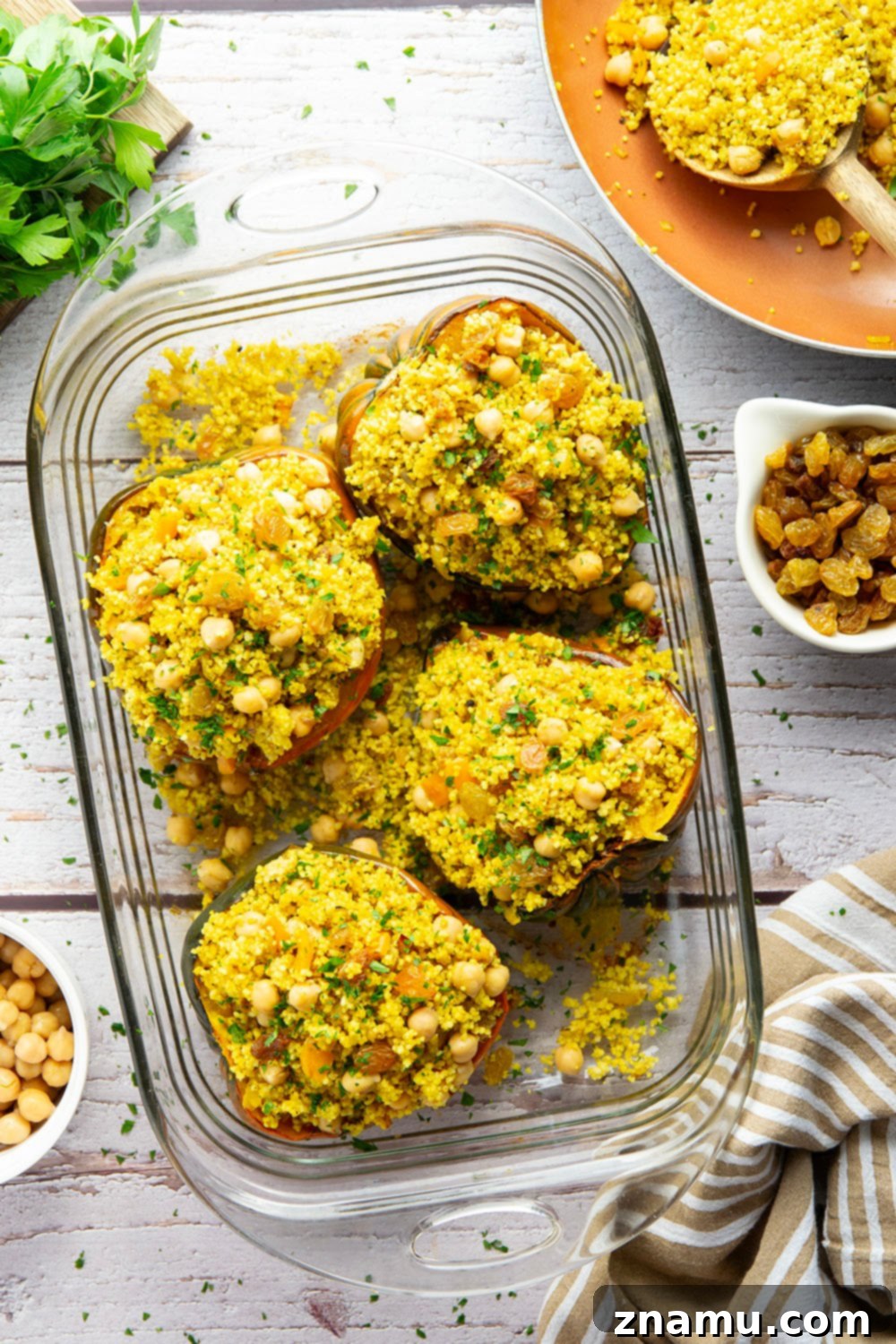 Roasted Acorn Squash with Spiced Couscous 5 This couscous stuffed acorn squash features fluffy Moroccan-spiced golden couscous piled into tender acorn squash boats.