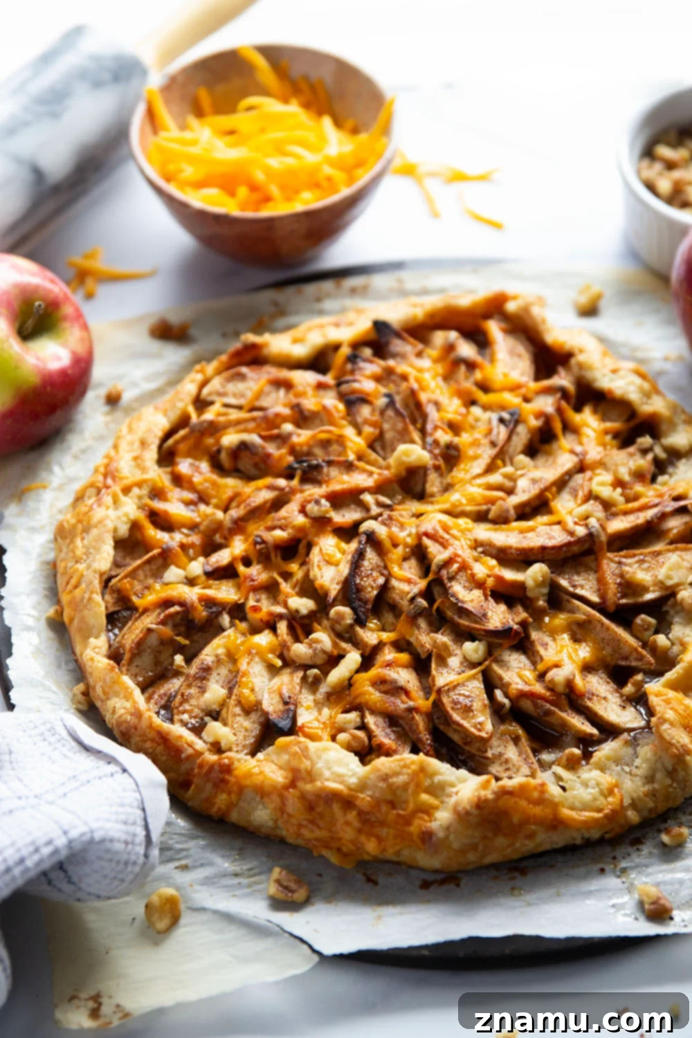 Rustic Apple Cheddar Galette 6 A single slice of Cheddar Apple Galette, revealing the flaky crust and juicy apple layers