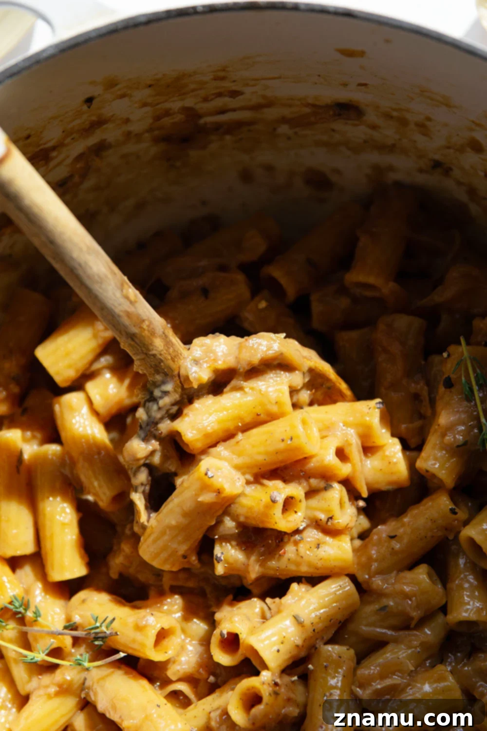 Cheesy One-Pot French Onion Pasta 6 Overhead view of the One-Pot French Onion Soup Pasta, garnished with fresh thyme, ready to be served from the pot.