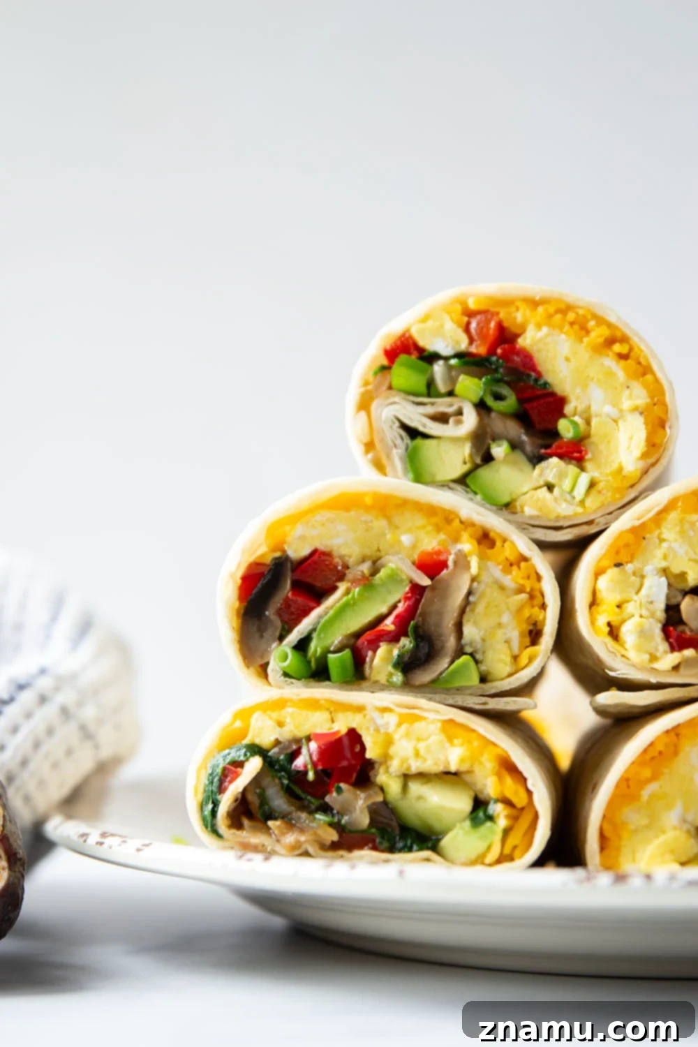 Plant-Powered Morning Wraps 2 Jam-packed with sauteed vegetables, scrambled eggs, avocado, and cheddar, these vegetarian breakfast burritos whip up in minutes and are perfect for an on-the-go breakfast!