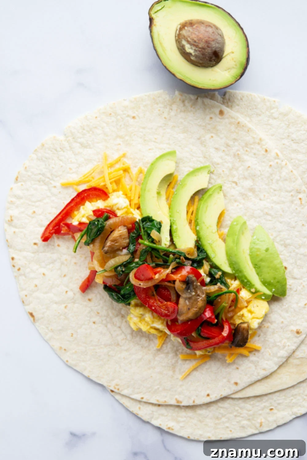 Plant-Powered Morning Wraps 4 Jam-packed with sauteed vegetables, scrambled eggs, avocado, and cheddar, these vegetarian breakfast burritos whip up in minutes and are perfect for an on-the-go breakfast!