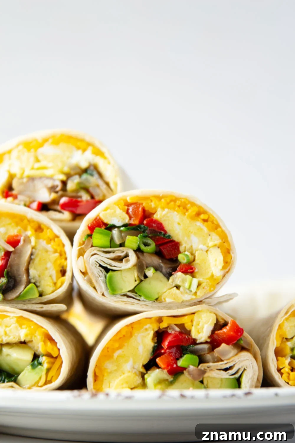 Plant-Powered Morning Wraps 5 Jam-packed with sauteed vegetables, scrambled eggs, avocado, and cheddar, these vegetarian breakfast burritos whip up in minutes and are perfect for an on-the-go breakfast!
