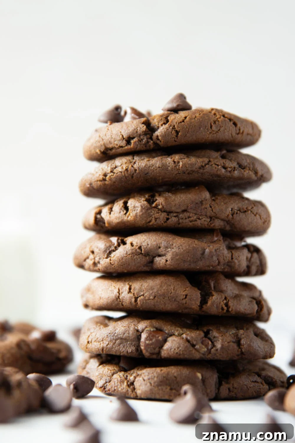 Decadent Double Chocolate Cookies 3 A close-up of a double chocolate chip cookie, revealing its perfectly cracked top and a glimpse of melted chocolate chips.