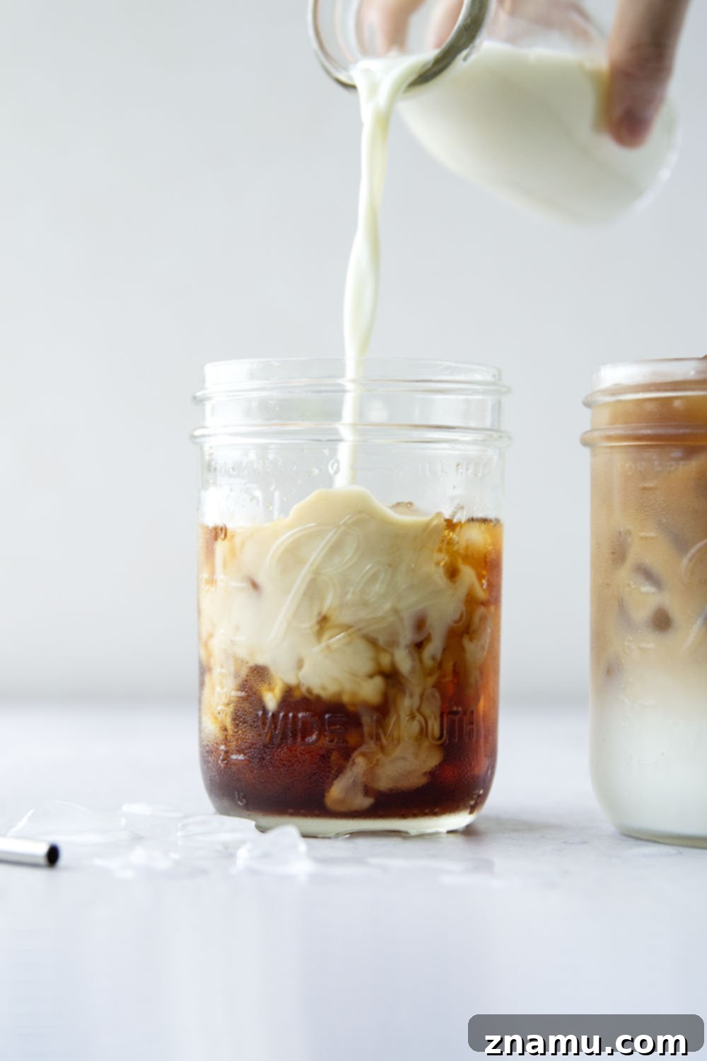 Ultimate Iced Coffee 2 A refreshing glass of homemade iced coffee with ice cubes and milk, ready to be enjoyed.