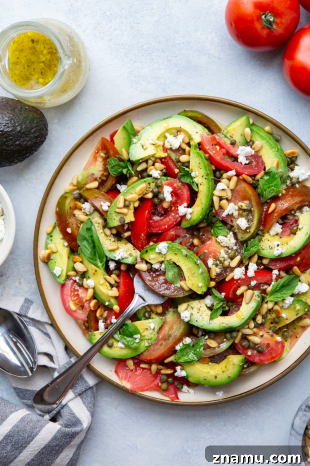 Vibrant Avocado Tomato Salad 2 Vibrant Avocado Tomato Salad with fresh basil and a light dressing, a perfect summer side dish.