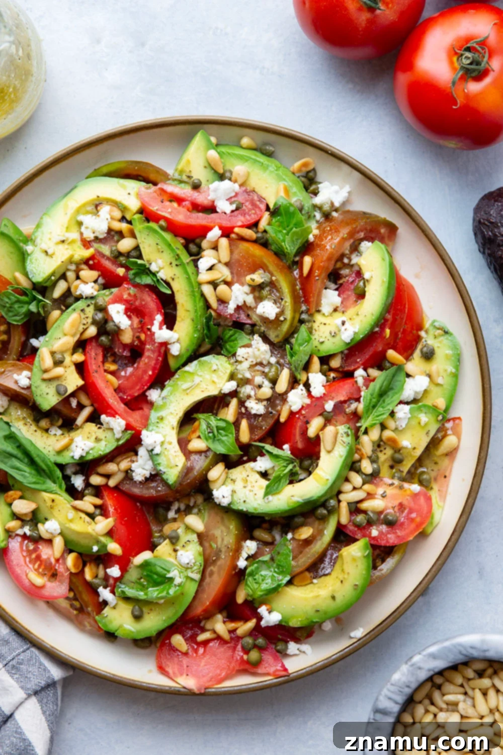 Vibrant Avocado Tomato Salad 3 Close-up of freshly sliced avocado and tomato in a salad, ready to be dressed.