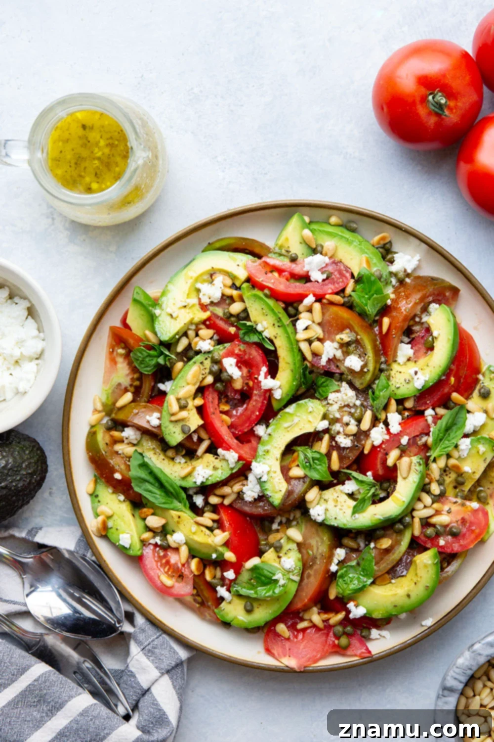Vibrant Avocado Tomato Salad 5 An overhead shot of vibrant sliced tomatoes and creamy avocados layered on a serving plate.