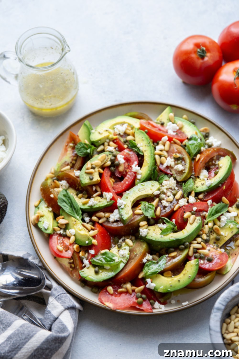 Vibrant Avocado Tomato Salad 6 A beautifully composed avocado tomato salad, drizzled with vinaigrette and garnished with fresh herbs and toppings.