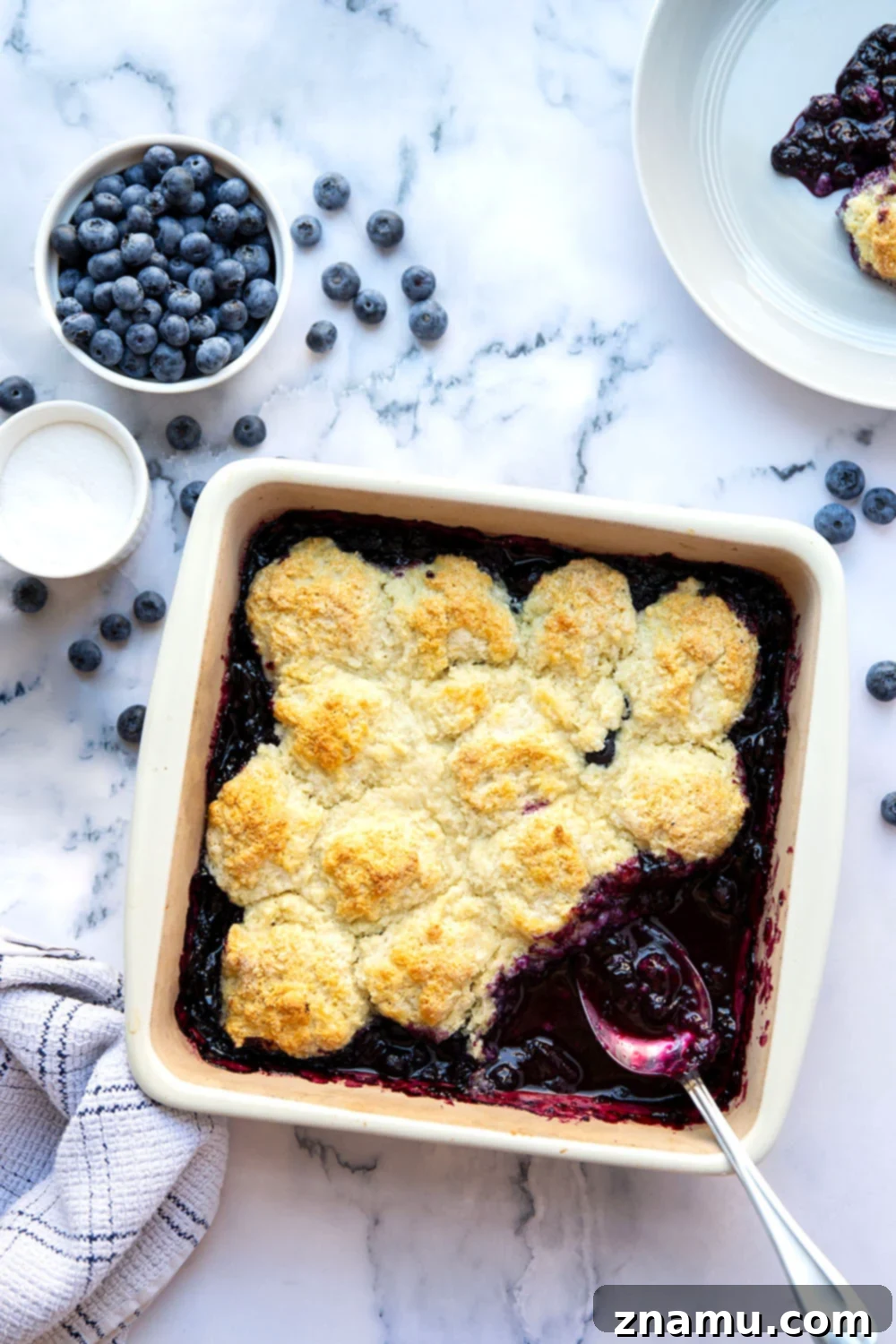 Ultimate Blueberry Cobbler 2 The Best Blueberry Cobbler: a classic blueberry cobbler with jammy filling and a sweet biscuit topping, perfect warm with whipped cream or ice cream.
