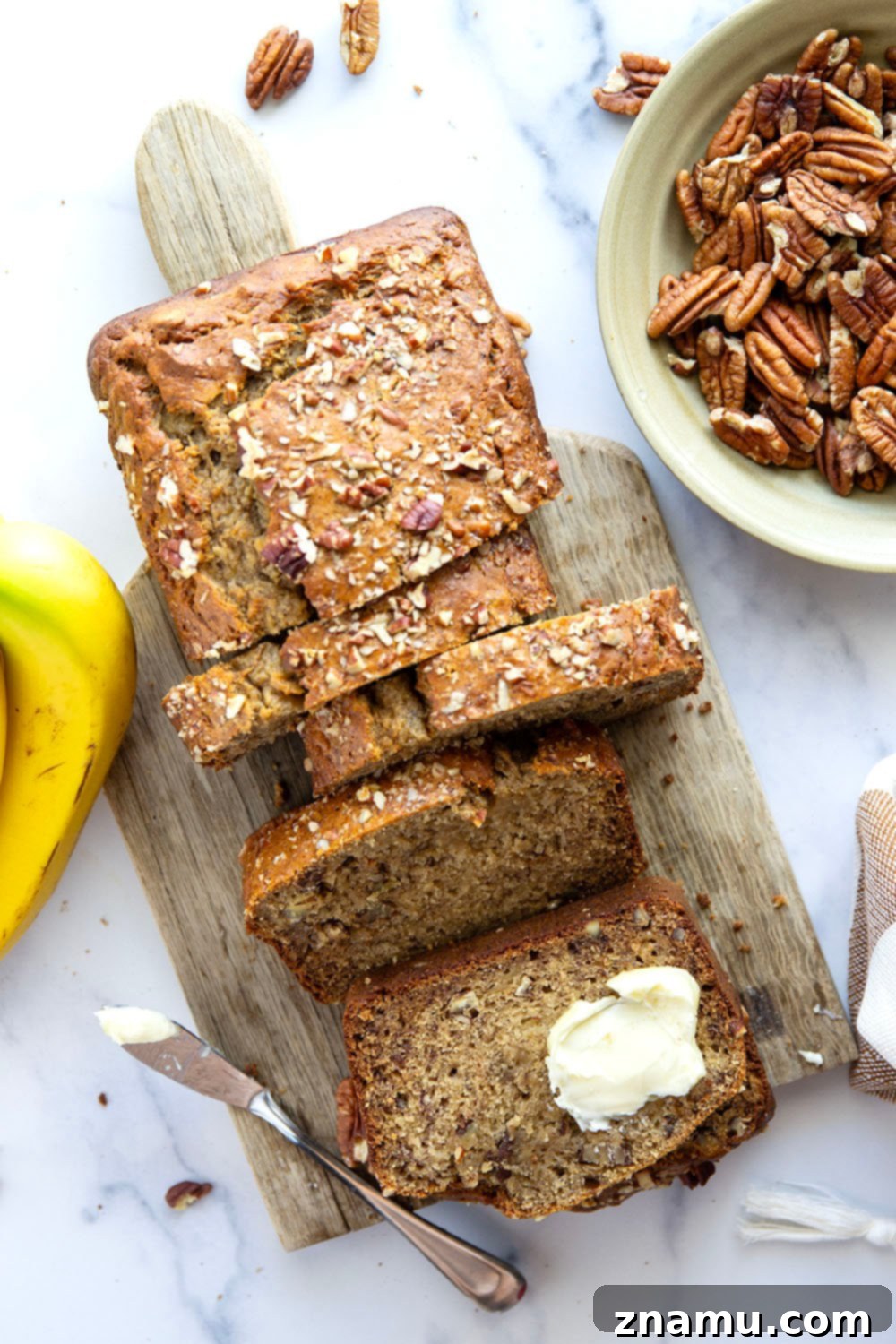 The Ultimate Banana Bread 3 Close-up of a slice of the best banana bread, showcasing its moist texture and pecans.
