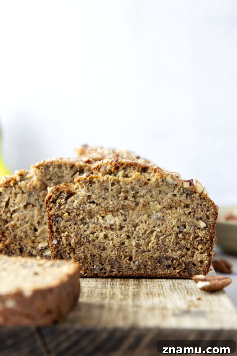 The Ultimate Banana Bread 4 A close-up of the delicious banana bread loaf with toasted pecans.