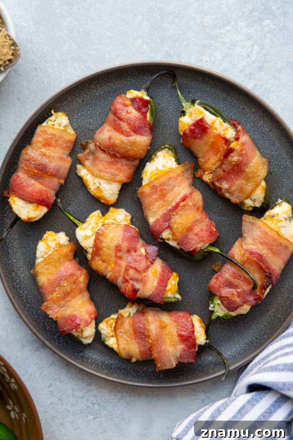 Crispy Bacon & Cream Cheese Jalapeño Bites 2 Wrapped in crispy brown sugar bacon and filled with a rich cheddar cream cheese filling, these bacon wrapped jalapeno poppers are the ultimate sweet and savory appetizer!
