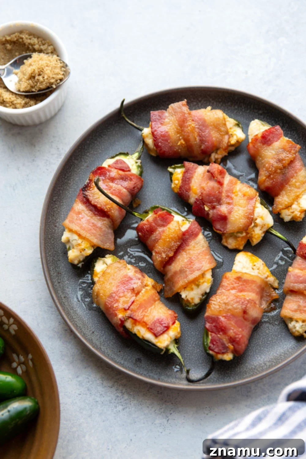 Crispy Bacon & Cream Cheese Jalapeño Bites 5 Wrapped in crispy brown sugar bacon and filled with a rich cheddar cream cheese filling, these bacon wrapped jalapeno poppers are the ultimate sweet and savory appetizer!