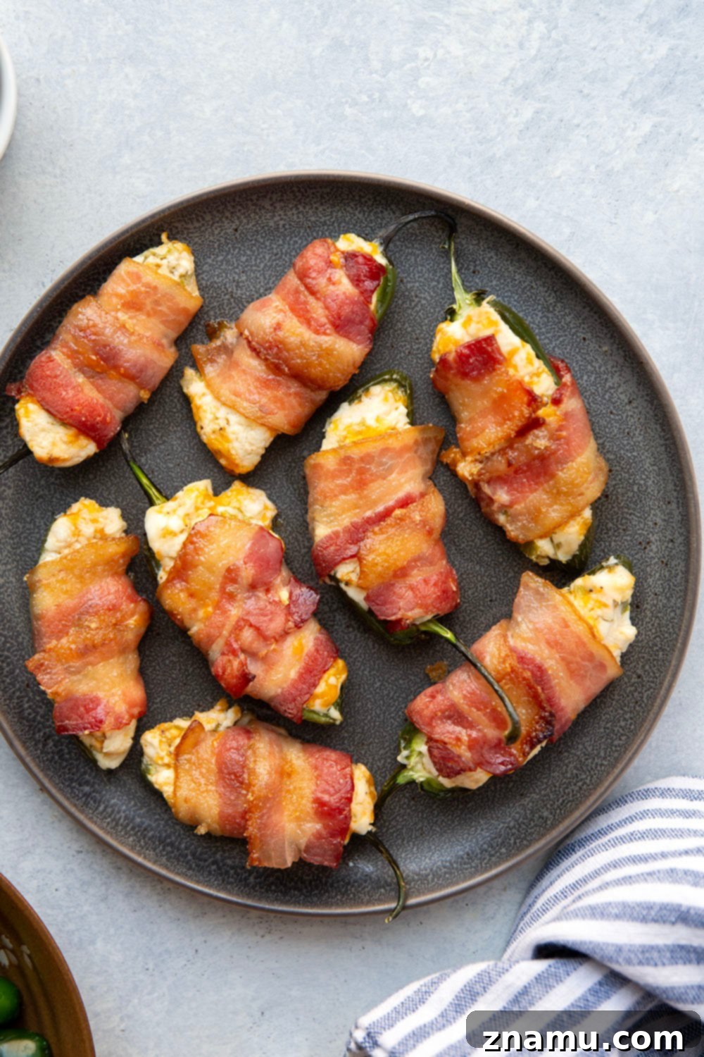 Crispy Bacon & Cream Cheese Jalapeño Bites 6 Wrapped in crispy brown sugar bacon and filled with a rich cheddar cream cheese filling, these bacon wrapped jalapeno poppers are the ultimate sweet and savory appetizer!