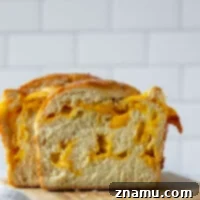 Irresistible Homemade Cheese Bread 9 Perfectly soft and fluffy and swirled with pockets of gooey cheddar cheese, this homemade cheese bread is easy to make and a fun baking project!