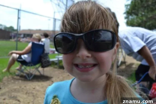Reliving Summer 2014 11 Rachel and another person making funny faces and entertaining themselves at a baseball game.