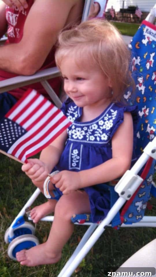 Reliving Summer 2014 13 Lilly, a young girl, celebrating the 4th of July with a patriotic outfit and a big smile.