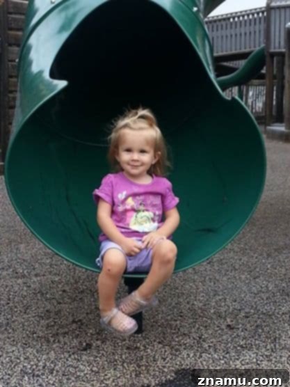 Reliving Summer 2014 17 Lilly, a young niece, looking curiously at something while being held, showcasing a sweet moment.