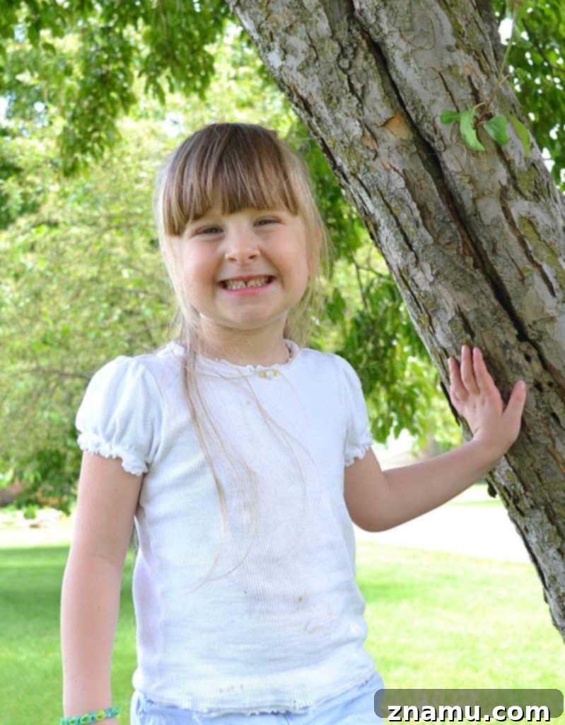 Reliving Summer 2014 19 Rachel, a young girl, beams happily while holding a slice of rich chocolate birthday cake.