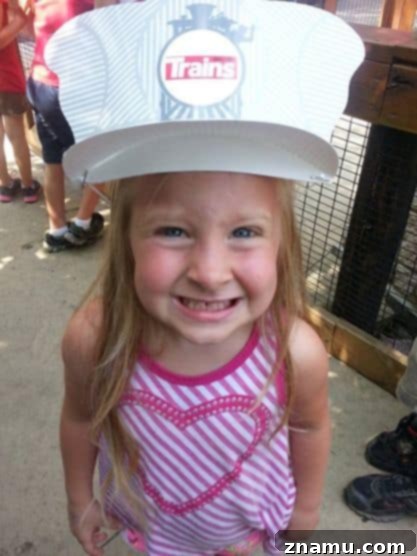 Reliving Summer 2014 23 Rachel, a young girl, confidently wearing a whimsical hat, showcasing her charm.