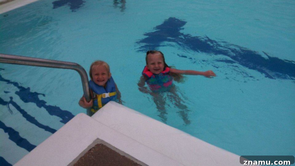 Reliving Summer 2014 26 Children happily playing and swimming in a pool, enjoying a sunny summer day.