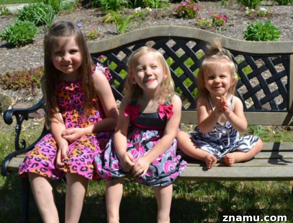 Reliving Summer 2014 8 A candid photo of a family, including three young girls, enjoying a fun outdoor photoshoot together.