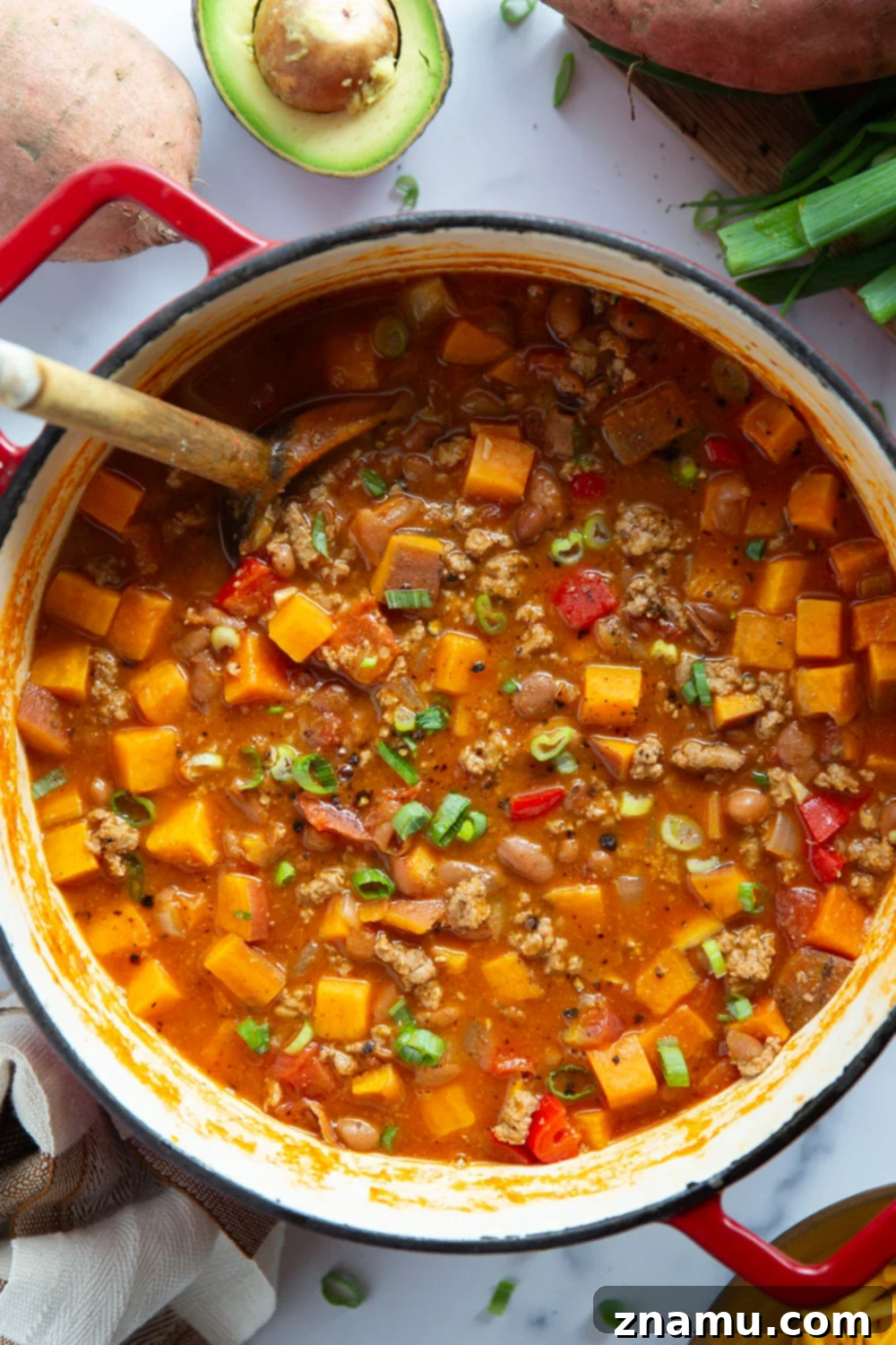 Ingredients for Sweet Potato Turkey Chili laid out on a wooden board