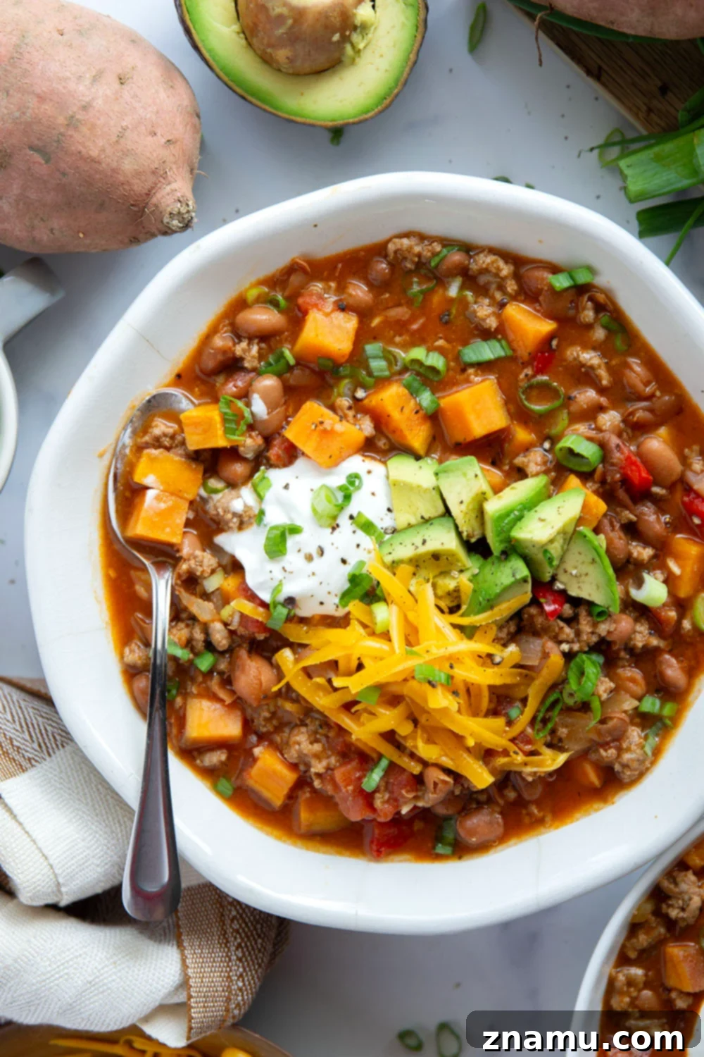 Another view of a steaming bowl of Sweet Potato Turkey Chili, perfect for cold weather