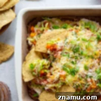 Ultimate Fiesta 7-Layer Dip 8 This 7-layer taco dip features layers upon layers of refried beans, a rich cream cheese filling, and lots of shredded lettuce, cheese, tomatoes, and peppers on top.