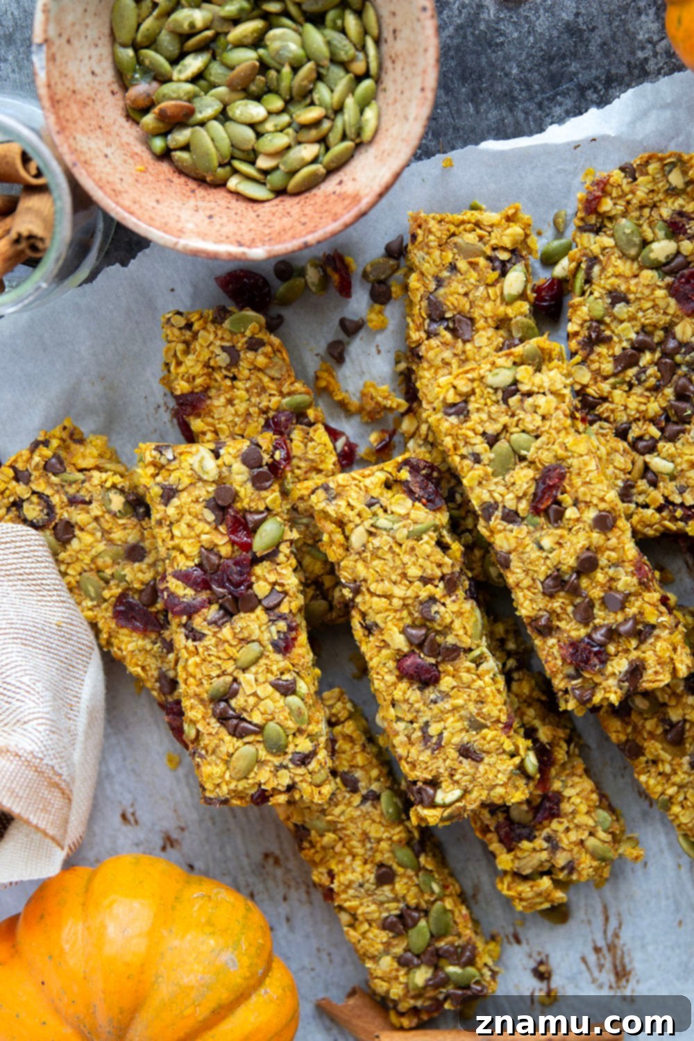 Spiced Pumpkin Oat Bars 4 Stack of pumpkin granola bars, cut into neat rectangles, with an appealing top layer of various mix-ins