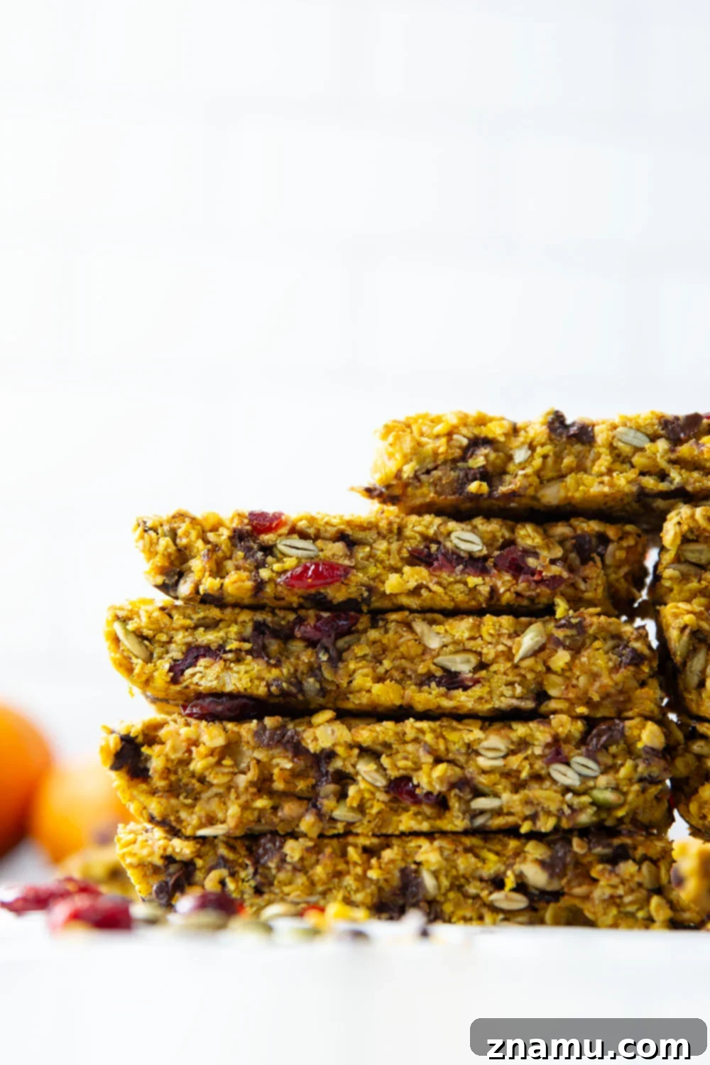 Spiced Pumpkin Oat Bars 5 Ingredients for pumpkin granola bars laid out on a kitchen counter: pumpkin puree, oats, honey, spices, and various mix-ins